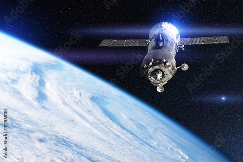 Fototapeta Naklejka Na Ścianę i Meble -  Space shuttle ship with astronauts on board flies in earth orbit above the vortex of clouds. Elements of this image furnished by NASA.