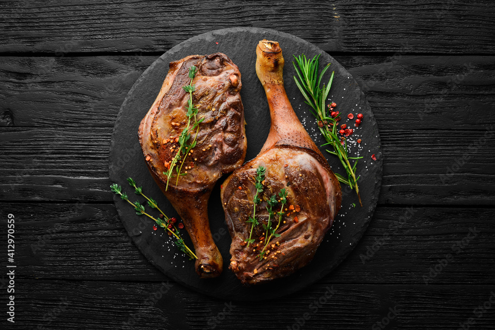 Baked duck thigh with spices and rosemary. Barbecue meat. Top view