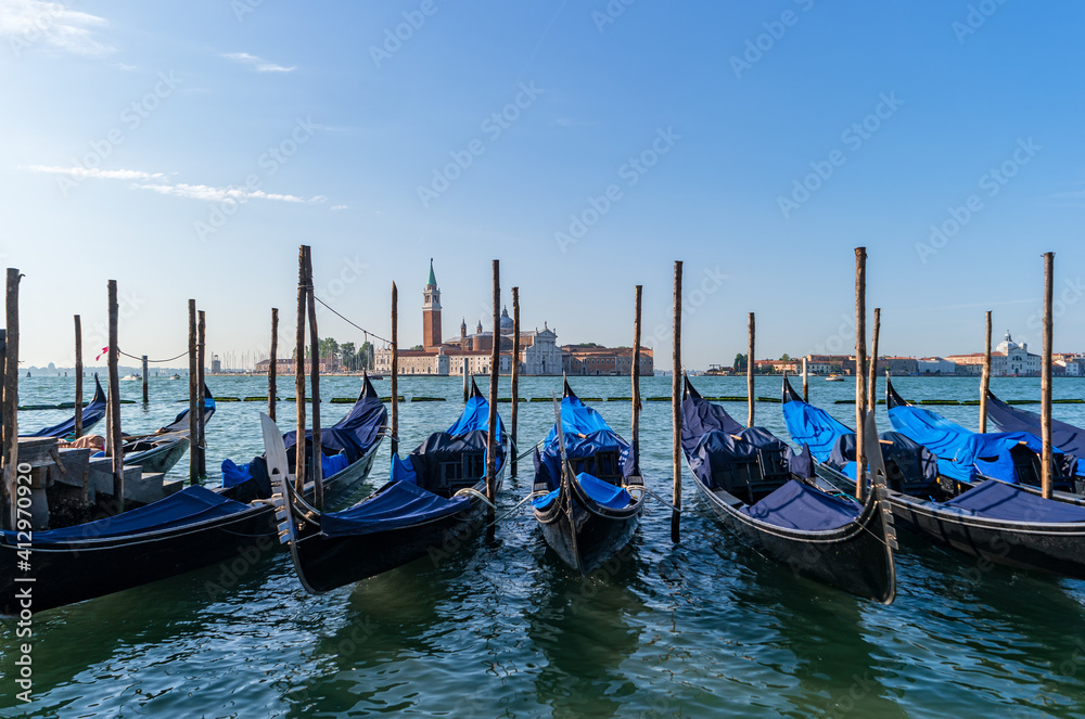 Venice, Italy. Gondolas at the pier against the background of the Cathedral of San Giorgio Maggiore.