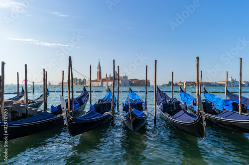 Venice, Italy. Gondolas at the pier against the background of the Cathedral of San Giorgio Maggiore. © Kristina Maikova