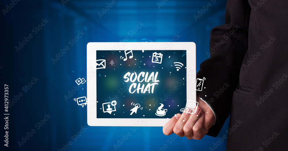 Young business person working on tablet and shows the inscription: SOCIAL CHAT Young business person working on tablet and shows the inscription: SOCIAL CHAT