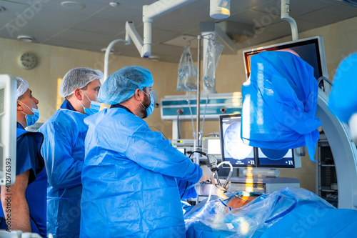 Surgeons working in operating room. Hospital background. Male doctors at work. Background of an operation room.