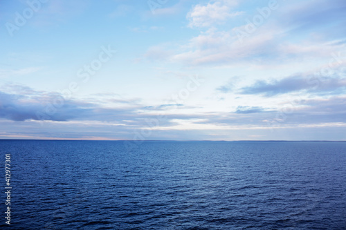 Landscape with the endless sea, horizon, and beautiful clouds