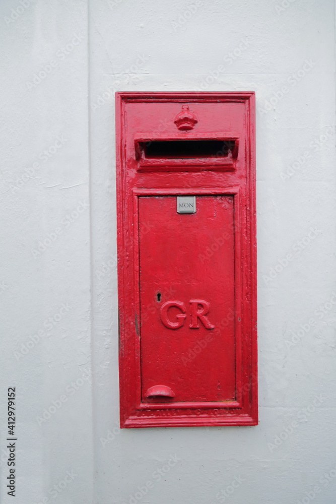 Historic mailbox in white wall 