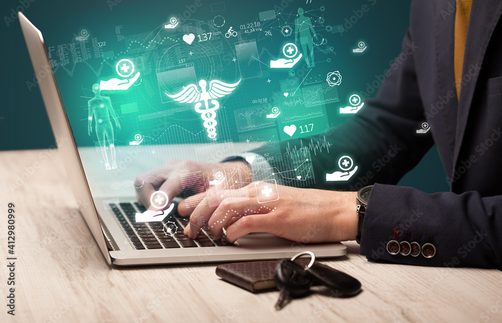 hand browsing on the internet for medical issues with pharmacy icons coming out from the screen hand browsing on the internet for medical issues with pharmacy icons coming out from the screen