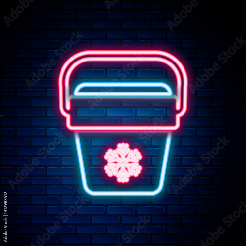 Glowing neon line Cooler bag icon isolated on brick wall background. Portable freezer bag. Handheld refrigerator. Colorful outline concept. Vector.
