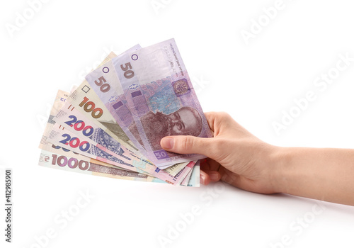 Woman holding Ukrainian money on white background, closeup