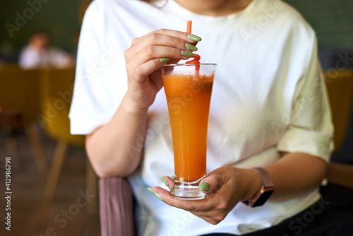 the girl holds a cocktail in her hands