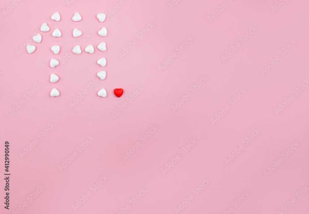 Number 14 formed with hearts candies on pink background. Copy space.