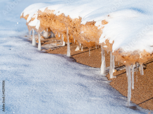 Wallpaper Mural In the winter, stones are icy on the sea shore. Icicles hung from large pieces of ice Torontodigital.ca