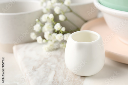 Different dishware and marble board on table  space for text