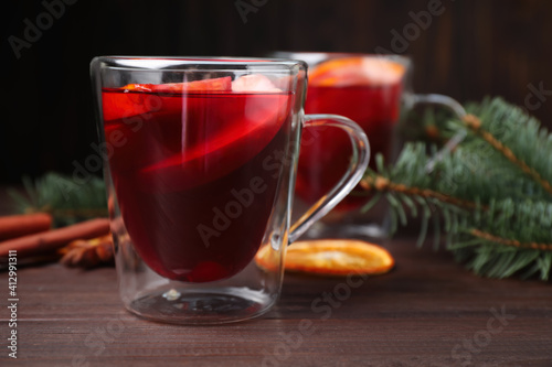 Delicious hot mulled wine on wooden table