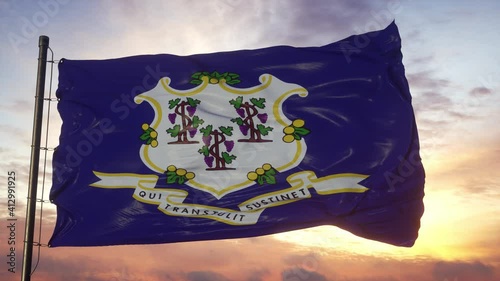 Flag of Connecticut waving in the wind against deep beautiful sky at sunset photo