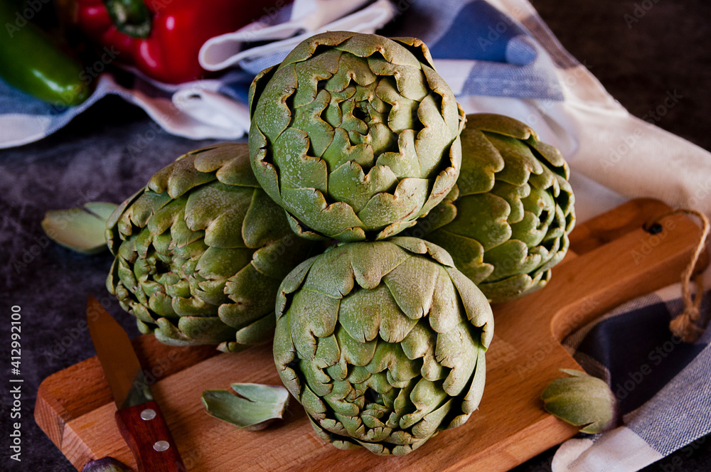 Artichokes on a wooden board Artichokes on a wooden board