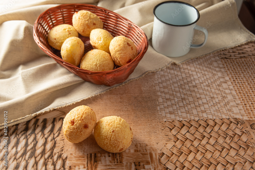 Cheese bread from Brazil, Arrangement with cheese bread, fabric and accessories on a table, selective focus. Cheese bread from Brazil, Arrangement with cheese bread, fabric and accessories on a table, selective focus.