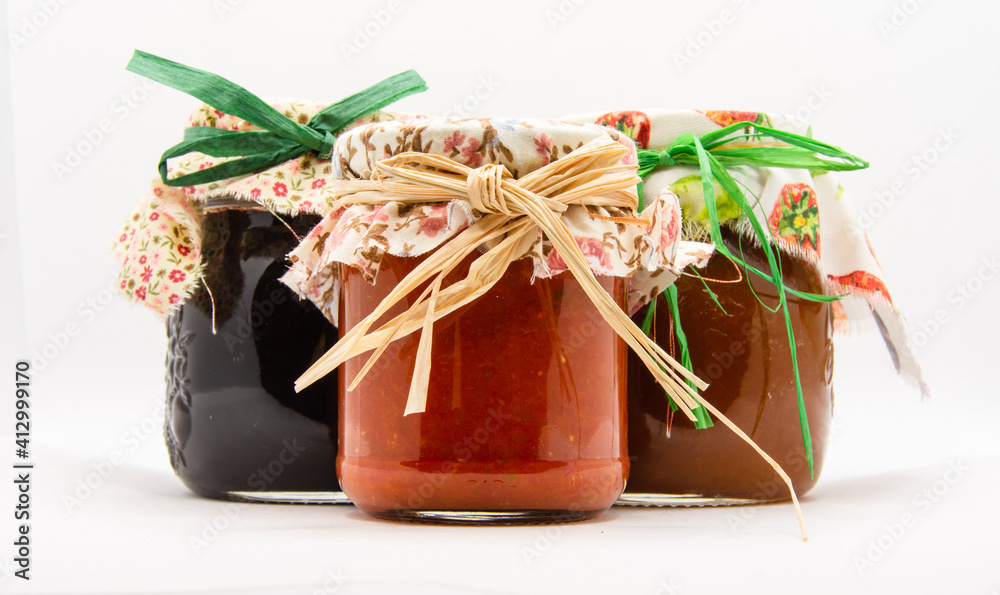 Canning food jars of homemade jams preserved in glass storage Canning food jars of homemade jams preserved in glass storage