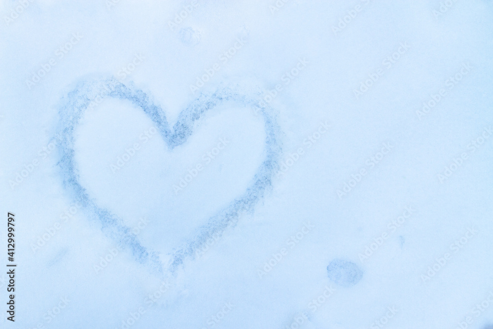 Heart painted in the snow. Copy space