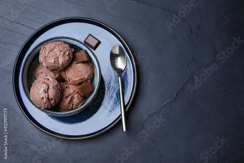 Yummy chocolate ice cream served on black table, top view. Space for text