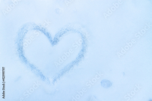 Heart painted in the snow. Copy space