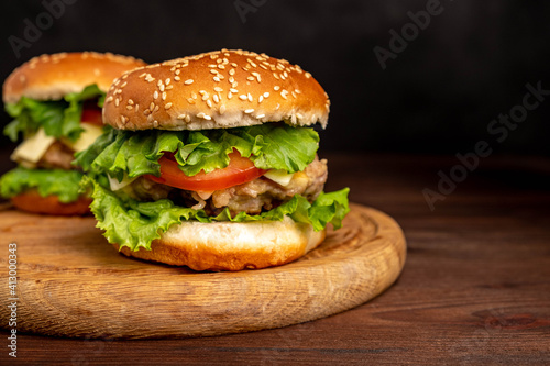 Fresh tasty burger on a blue background. Сheeseburger with chicken cutlet