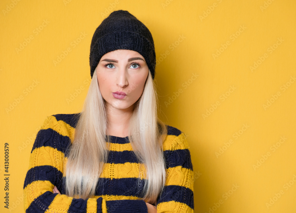 Young woman with purses lips being questioned while thinking. Girl looking up and need inspiration, isolated over white background