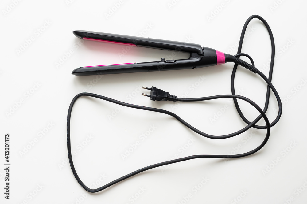 a straightening iron on a white background a straightening iron on a white background