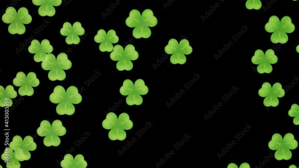 Green shamrocks flying and rotating on black background. Conceptual motion design for St. Patrick's Day Green shamrocks flying and rotating on black background. Conceptual motion design for St. Patrick's Day