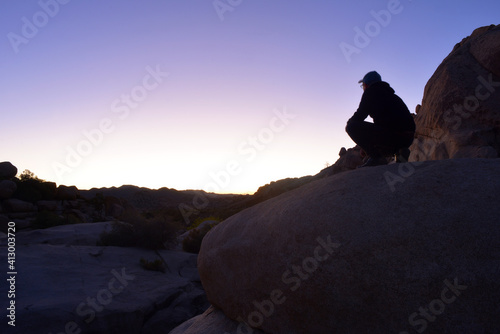 A person watching the sun goes down in the beautiful landscape at the joshua tree national park, USA