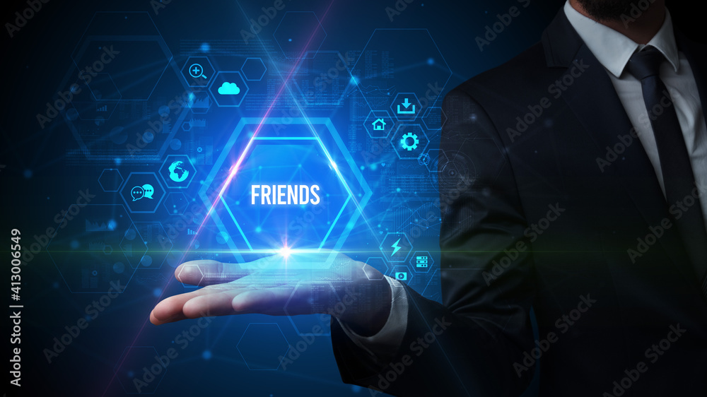 Man hand holding FRIENDS inscription, social media concept Man hand holding FRIENDS inscription, social media concept