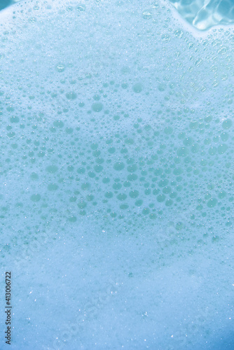 water foam and bubbles of blue color as background. cosmetology concept