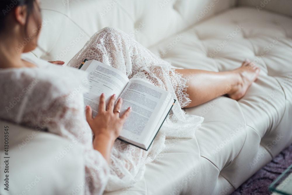 girl with black hair reads a book in Russian girl with black hair reads a book in Russian