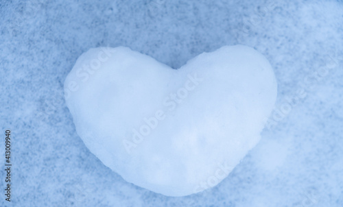 
Snowy heart close up in winter. Love symbol for valentine's day and eighth march
