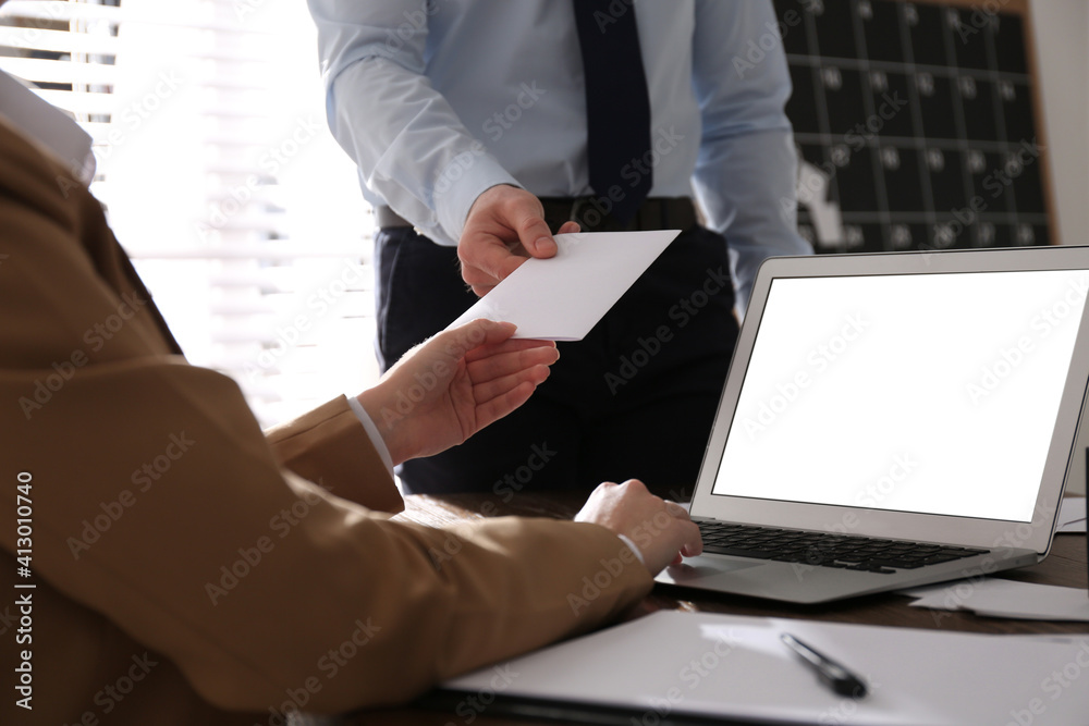 Employee giving resignation letter to boss in office, closeup - obrazy, fototapety, plakaty 