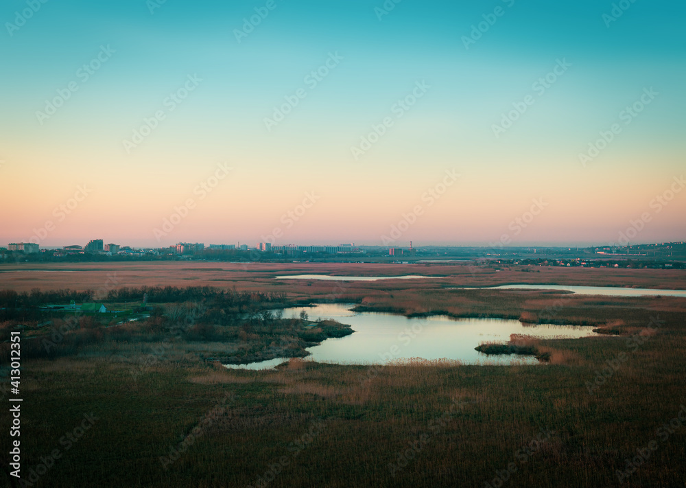 landscape with the lake and urban horizon at blue hour. Dzemete, Anapa, Russia