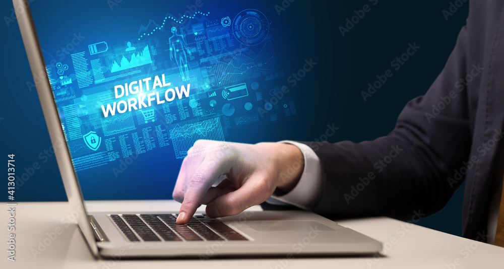 Businessman working on laptop with DIGITAL WORKFLOW inscription, cyber technology concept