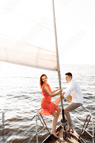 Couple in love on a yacht in the blue sea. © Александр Шуневич