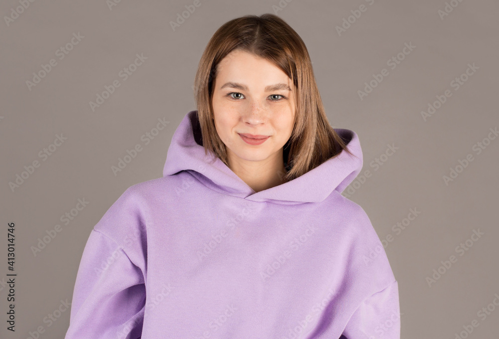 Fototapeta premium Portrait of young beautiful cute cheerful girl smiling looking at camera over gray background.