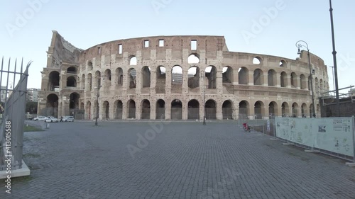 Rome, Italy - February 2,2021: Pov walking to Coliseum or Amphitheatrum Flavium in italian Colosseo , largest amphitheater in the world , a tourist attraction for architecture and ancient Rome history photo