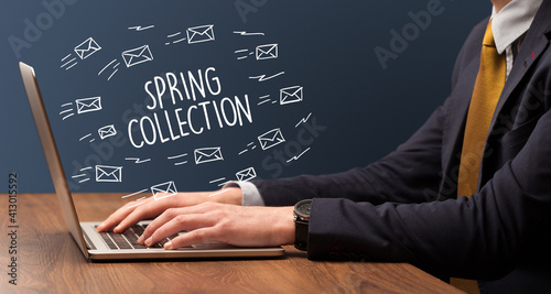 Businessman working on laptop with SPRING COLLECTION inscription, online shopping concept