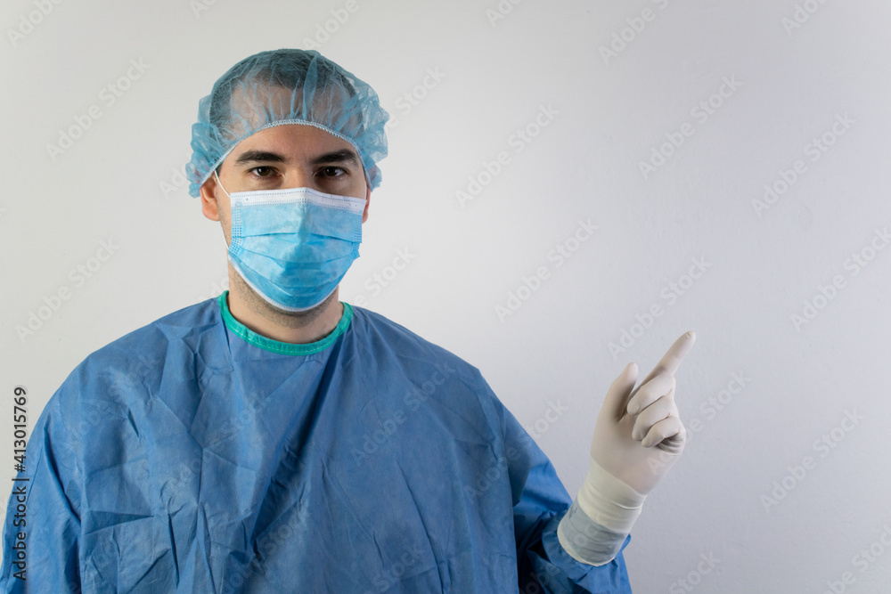 The main subject is out of focus, young male surgeon medical gloves show point The main subject is out of focus, young male surgeon medical gloves show point