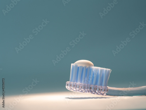 toothbrush with the right amount of toothpaste. concept of proper dental hygiene, dental care photo
