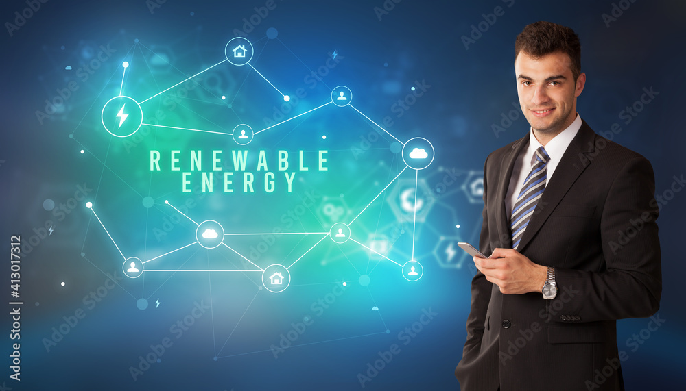 Businessman in front of cloud service icons with RENEWABLE ENERGY inscription, modern technology concept Businessman in front of cloud service icons with RENEWABLE ENERGY inscription, modern technology concept