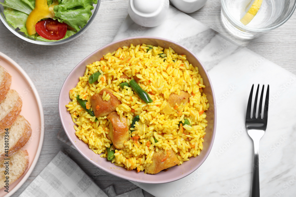 Delicious rice pilaf with meat served on table, flat lay Delicious rice pilaf with meat served on table, flat lay