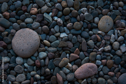 Beautiful river stones of different sizes in gray tones. Background concept.