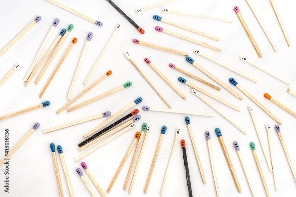 Multicolored matchsticks with faces painted on the heads Multicolored matchsticks with faces painted on the heads
