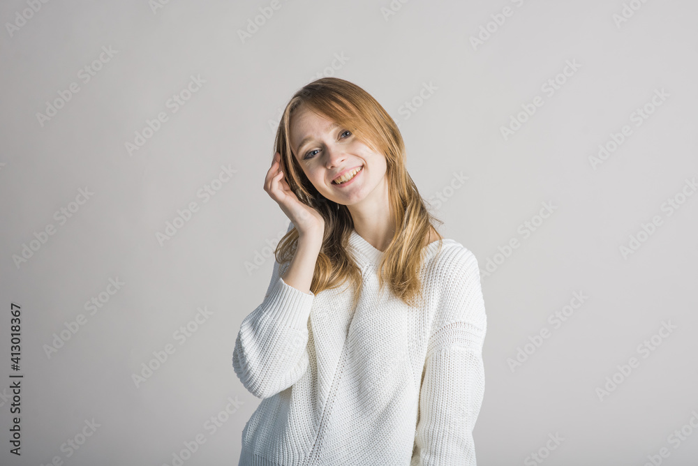 Portrait of a stylish and smiling girl on a white background in the studio Portrait of a stylish and smiling girl on a white background in the studio
