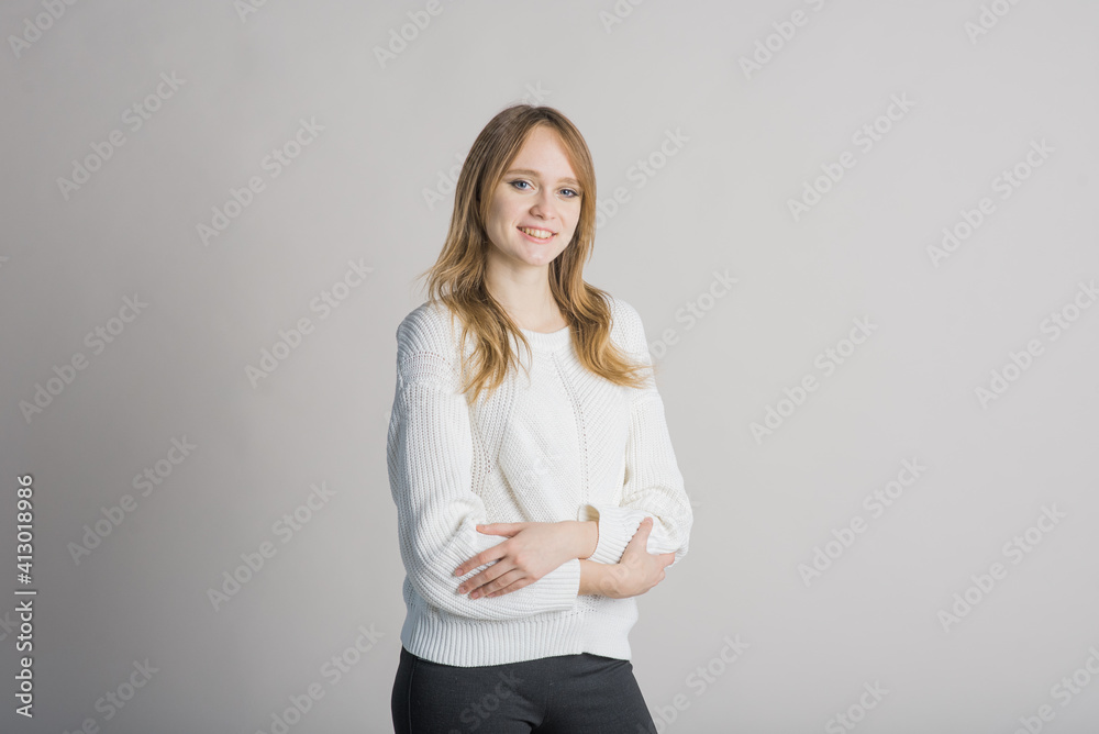 Portrait of a stylish and smiling girl on a white background in the studio Portrait of a stylish and smiling girl on a white background in the studio