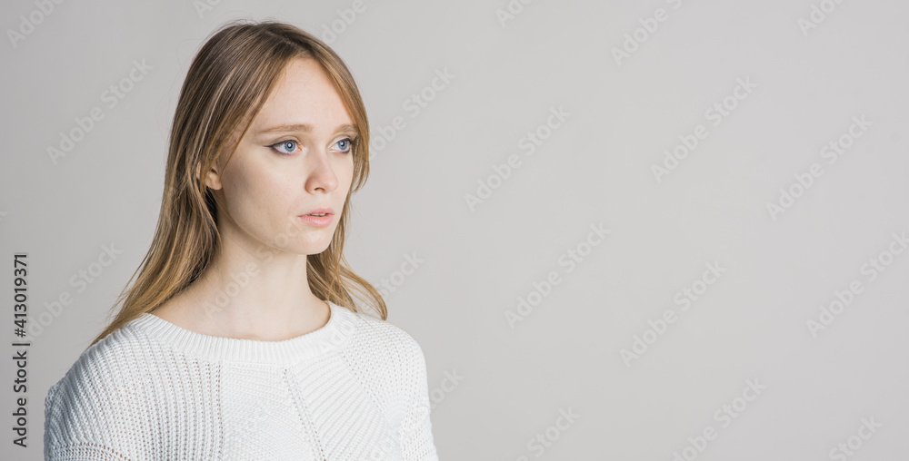 Portrait of a beautiful girl on a white background in the studio with a place for writing text Portrait of a beautiful girl on a white background in the studio with a place for writing text