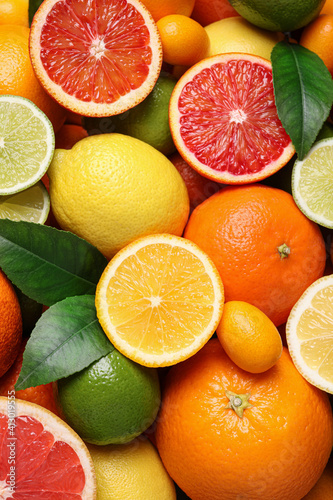 Different ripe citrus fruits as background  closeup