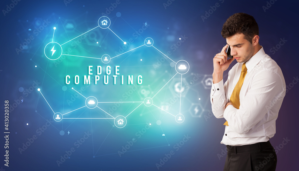 Businessman in front of cloud service icons with EDGE COMPUTING inscription, modern technology concept Businessman in front of cloud service icons with EDGE COMPUTING inscription, modern technology concept